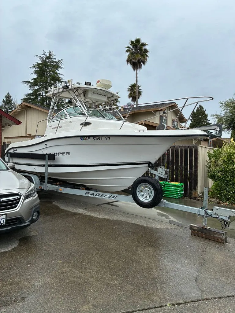 The Image of 2002 Seaswirl 2301 WA Striper on trailer in driveway. - 0