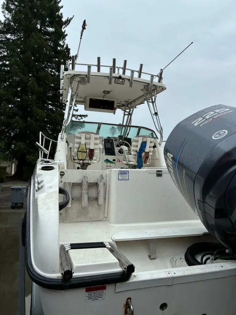 Slide: The Image of 2002 Seaswirl 2301 WA Striper boat with outboard motor. - 3