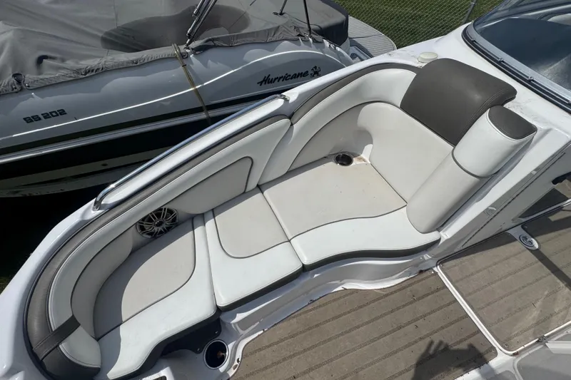 Slide: The Image of 2013 Yamaha Boats 242 Limited S on trailer, covered, parked on grass. - 3