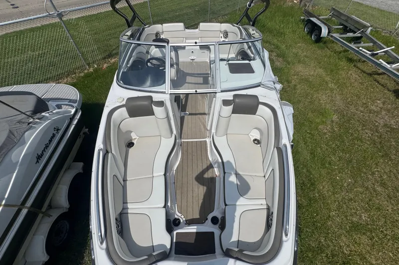 Slide: The Image of 2013 Yamaha Boats 242 Limited S interior with white seating and speaker. - 5