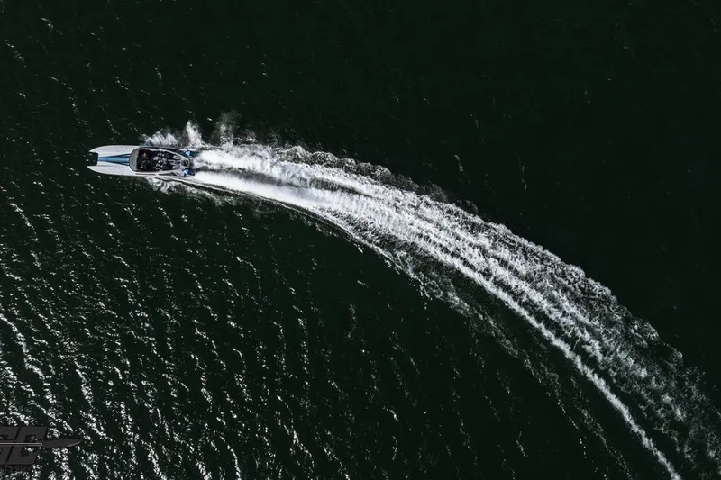 Slide: The Image of Aerial view of 2025 Interceptor 36 GTC speedboat creating a wake on dark water. - 12