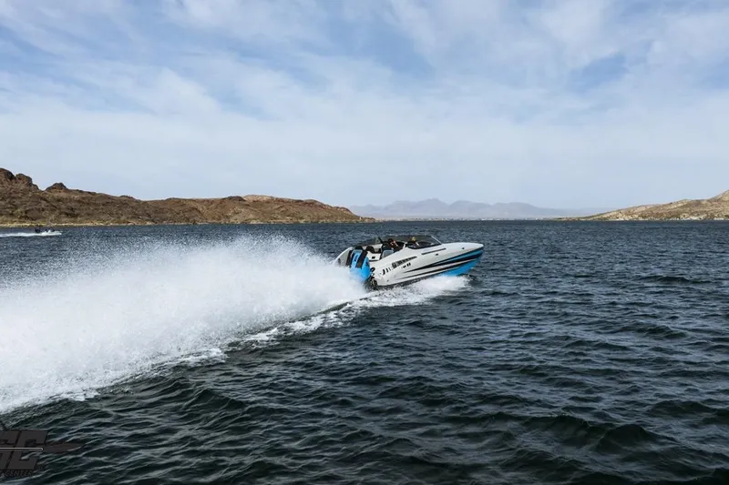 Slide: The Image of 2025 Interceptor 36 GTC speedboat cruising on a lake with scenic hills in the background. - 13