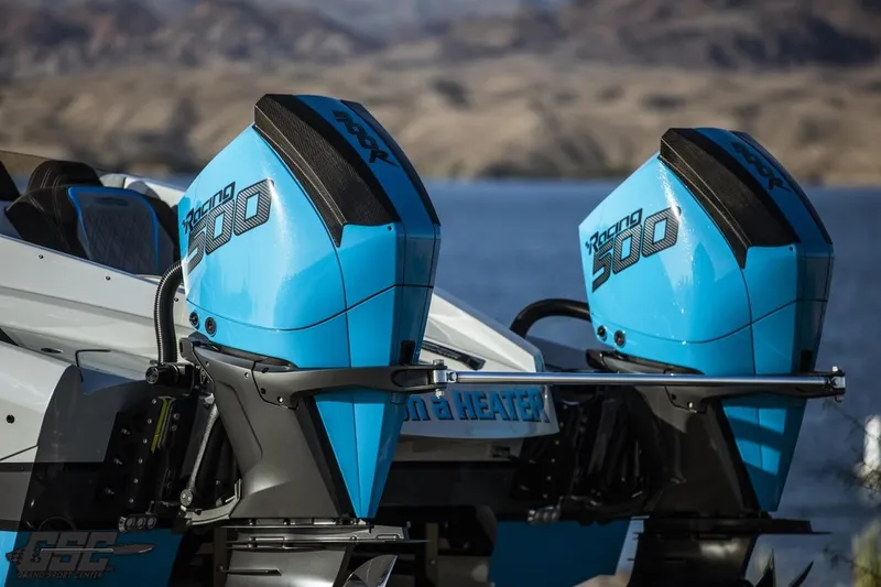 Slide: The Image of Twin blue racing engines on a 2025 Interceptor 36 GTC boat by the water. - 14