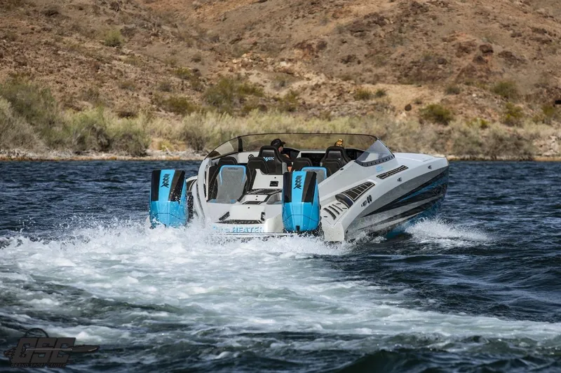Slide: The Image of 2025 Interceptor 36 GTC speedboat cruising on a scenic lake with rugged hills in the background. - 21