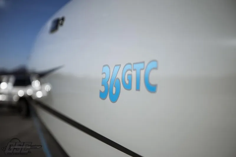 Slide: The Image of 2025 Interceptor 36 GTC boat with sleek design and blue logo detailing. - 22
