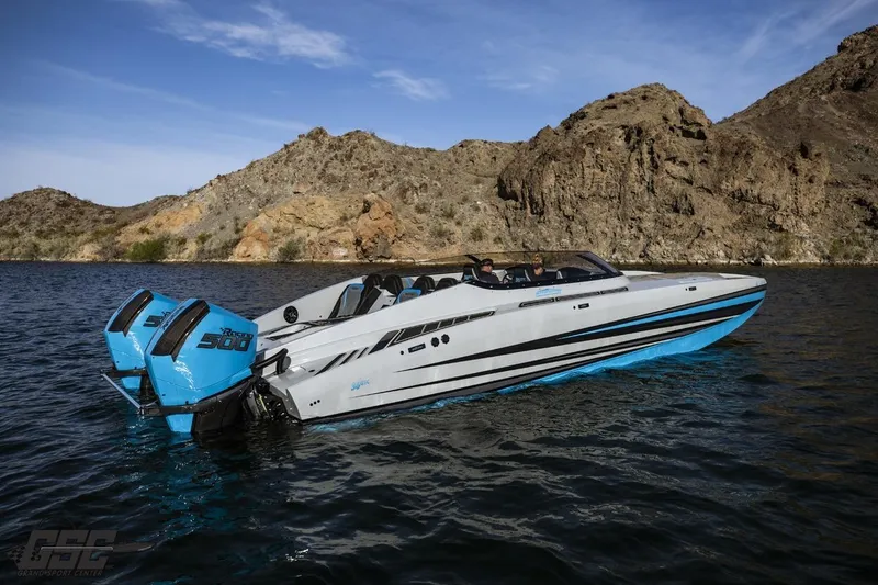 Slide: The Image of 2025 Interceptor 36 GTC speedboat on water, featuring twin outboard engines, with rocky landscape backdrop. - 26