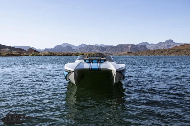 Slide: The Image of 2025 Interceptor 36 GTC boat on a serene lake with mountainous backdrop. - 28
