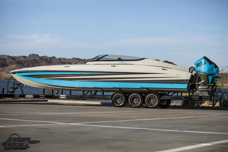 Slide: The Image of 2025 Interceptor 36 GTC boat on trailer by a lake, showcasing sleek design. - 3