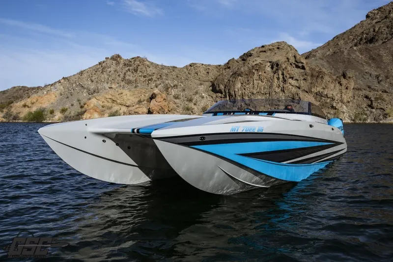 Slide: The Image of 2025 Interceptor 36 GTC boat on water, with rocky landscape background. - 32