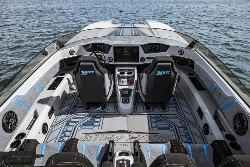 Slide: The Image of 2025 Interceptor 36 GTC boat interior with modern dashboard and seating on open water. - 48