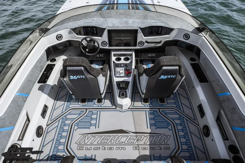 Slide: The Image of 2025 Interceptor 36 GTC boat interior with modern dashboard and seating on water. - 49
