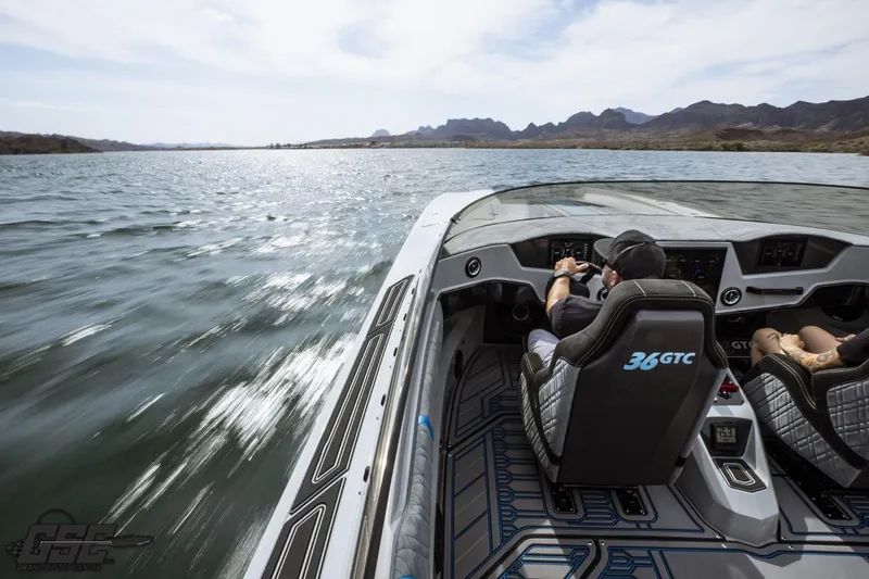 Slide: The Image of 2025 Interceptor 36 GTC speedboat cruising on a scenic lake with passengers. - 68