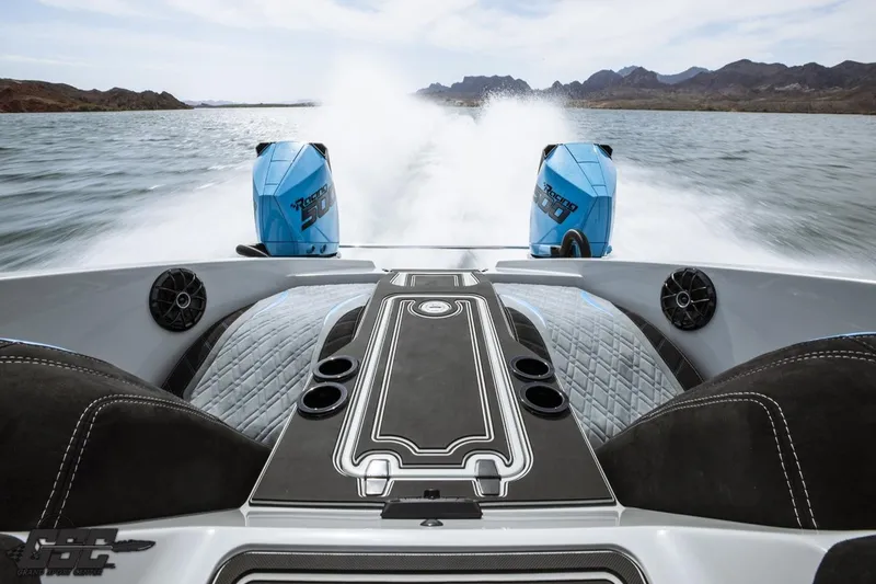 Slide: The Image of 2025 Interceptor 36 GTC boat with dual engines speeding on a scenic lake. - 69