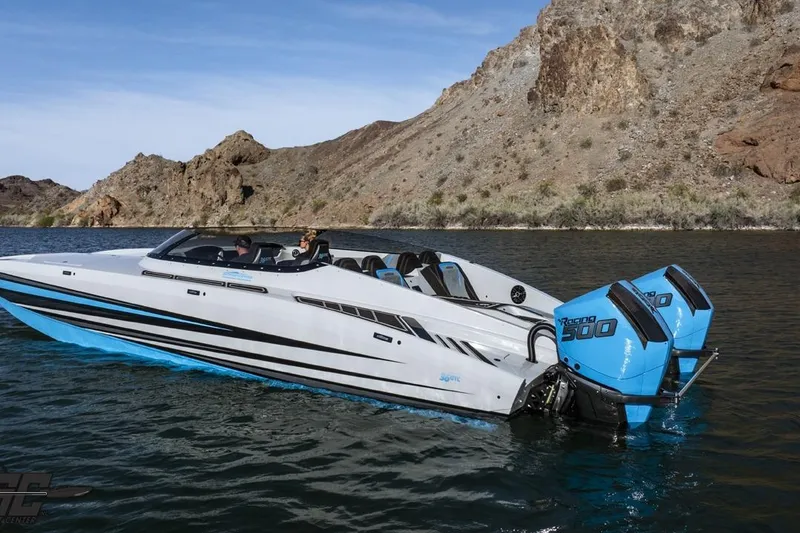 Slide: The Image of 2025 Interceptor 36 GTC speedboat cruising on a scenic lake with rocky hills in the background. - 9