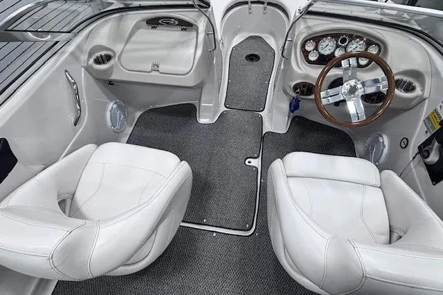 Slide: The Image of 2011 Glastron GT 205 Ski & Fish boat interior with white seats and dashboard. - 10