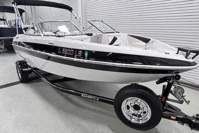 Slide: The Image of 2011 Glastron GT 205 Ski & Fish boat on trailer in showroom. - 21