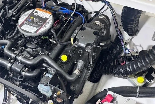 Slide: The Image of Engine compartment of a 2011 Glastron GT 205 Ski & Fish boat, showcasing detailed components. - 22