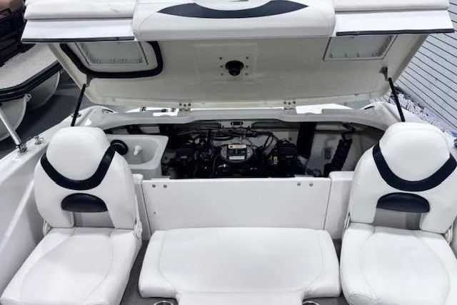 Slide: The Image of 2011 Glastron GT 205 Ski & Fish boat interior with open engine compartment and white seating. - 24
