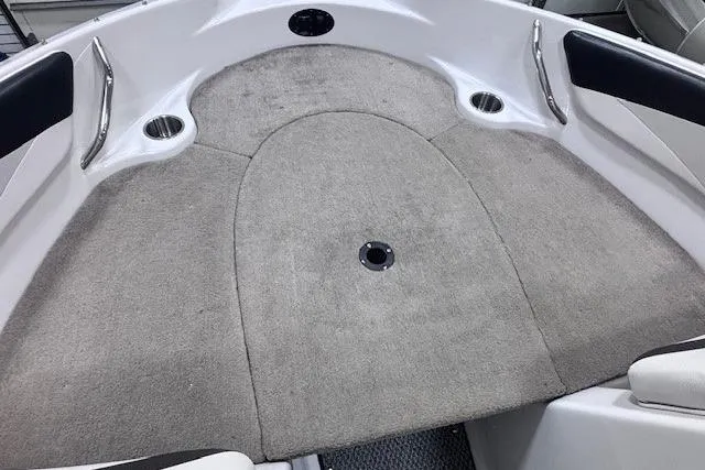 Slide: The Image of 2011 Glastron GT 205 Ski & Fish boat interior with carpeted bow area. - 28