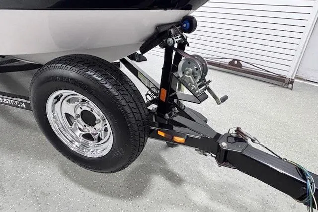 Slide: The Image of 2011 Glastron GT 205 Ski & Fish boat trailer with chrome wheel and winch system. - 31