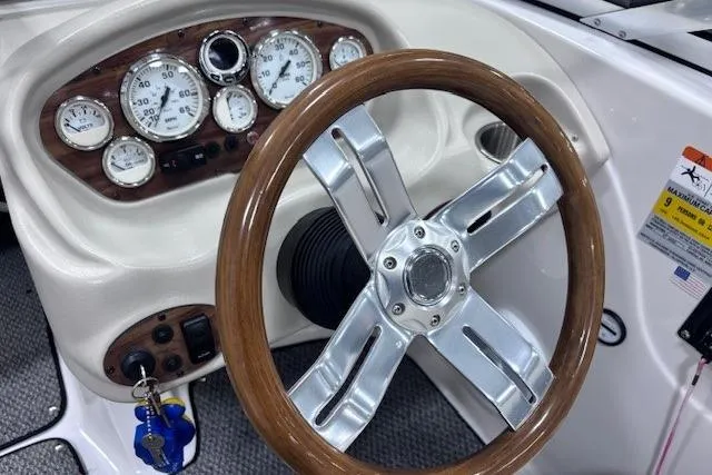 Slide: The Image of 2011 Glastron GT 205 Ski & Fish dashboard with wood-accented steering wheel and gauges. - 34