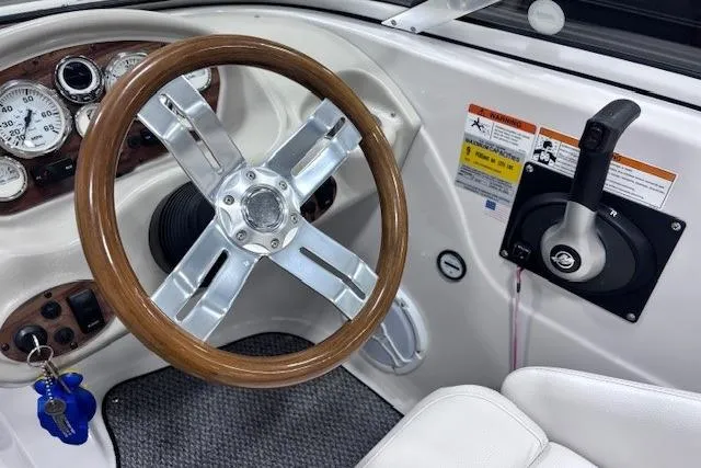 Slide: The Image of 2011 Glastron GT 205 Ski & Fish boat dashboard with wooden steering wheel and controls. - 4