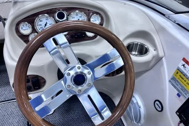 Slide: The Image of 2011 Glastron GT 205 Ski & Fish dashboard with wood-accented steering wheel and gauges. - 5