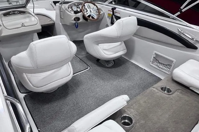 Slide: The Image of 2011 Glastron GT 205 Ski & Fish boat interior with white seating and gray carpet. - 6