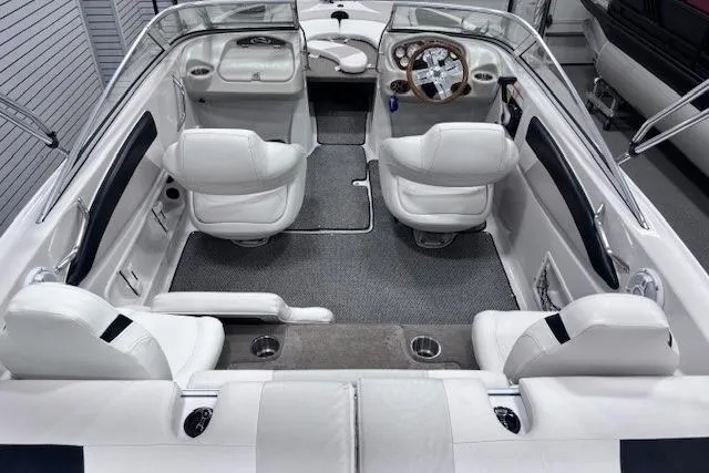Slide: The Image of 2011 Glastron GT 205 Ski & Fish boat interior with white seating and sleek dashboard design. - 8