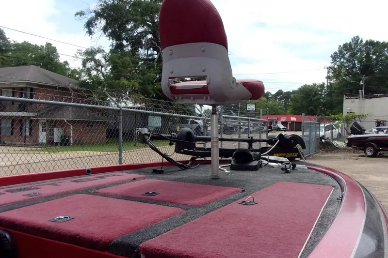 Slide: The Image of 1996 Skeeter ZX200 boat deck with red seating and fishing equipment. - 10