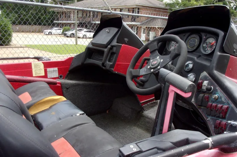 Slide: The Image of Interior of a 1996 Skeeter ZX200 boat showing steering wheel and dashboard controls. - 11