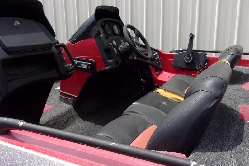Slide: The Image of 1996 Skeeter ZX200 boat interior with steering wheel and worn seating. - 17
