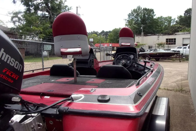 Slide: The Image of 1996 Skeeter ZX200 bass boat with Johnson outboard motor, parked outdoors. - 5