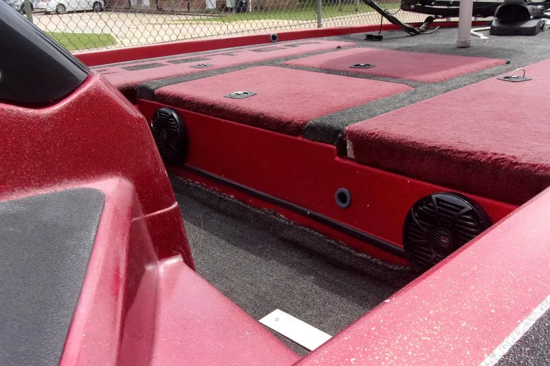 Slide: The Image of 1996 Skeeter ZX200 boat interior with red carpet and speaker system. - 9