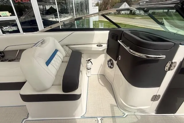 Slide: The Image of 2022 Regal LS6 Surf boat interior with white seating and modern dashboard. - 10