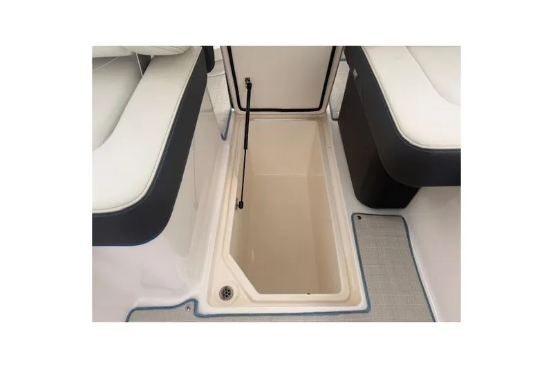 Slide: The Image of 2022 Regal LS6 Surf boat storage compartment with open hatch, showcasing interior space. - 13