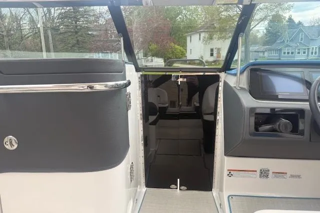 Slide: The Image of 2022 Regal LS6 Surf boat interior with open cabin door, showcasing sleek design and modern features. - 14