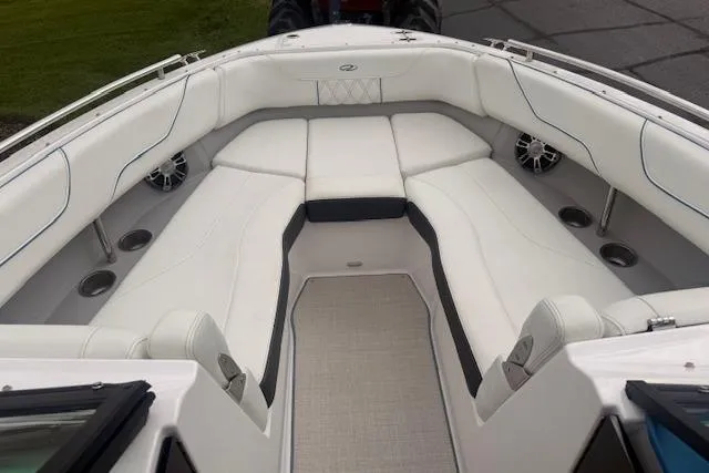Slide: The Image of Luxurious interior of 2022 Regal LS6 Surf boat with white seating and cup holders. - 15