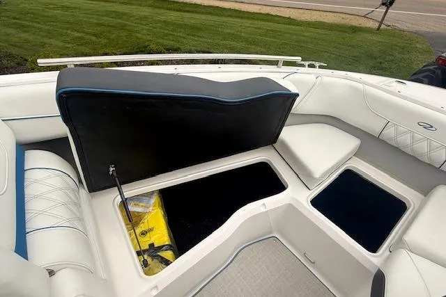 Slide: The Image of 2022 Regal LS6 Surf boat interior with open storage compartments and white seating. - 18