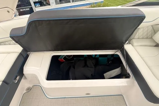 Slide: The Image of Open storage compartment in 2022 Regal LS6 Surf boat, showcasing spacious interior. - 23