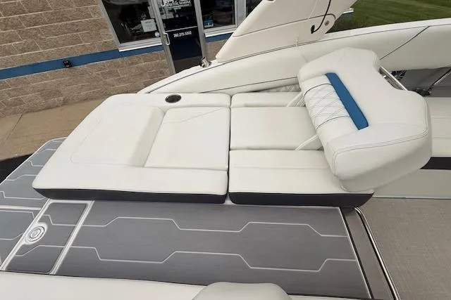 Slide: The Image of 2022 Regal LS6 Surf boat with luxurious white seating and modern design. - 26