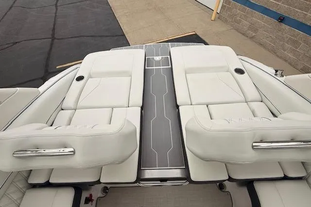 Slide: The Image of 2022 Regal LS6 Surf boat with luxurious white seating and sleek design. - 27