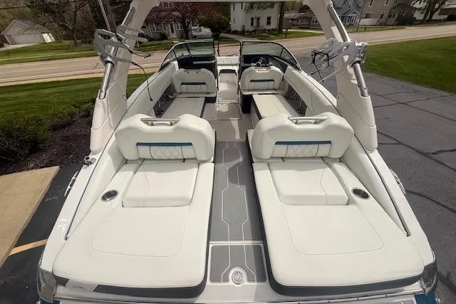 Slide: The Image of 2022 Regal LS6 Surf boat with spacious white seating and sleek design. - 3