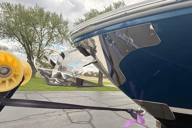Slide: The Image of 2022 Regal LS6 Surf boat on trailer, showcasing sleek blue hull and stainless steel accents. - 34
