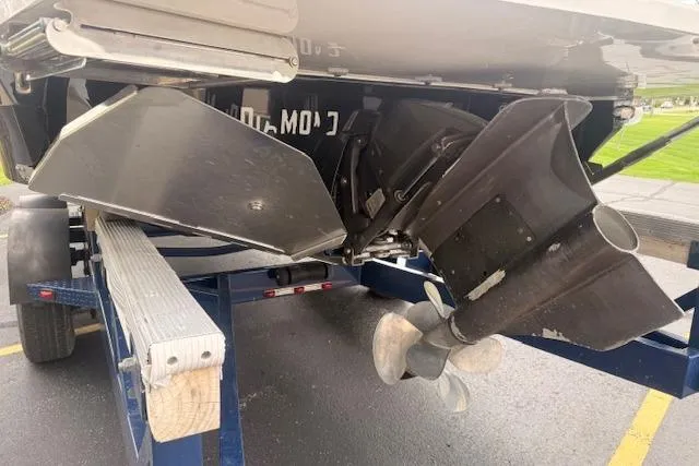 Slide: The Image of 2022 Regal LS6 Surf boat on trailer, showcasing propeller and hull details. - 36