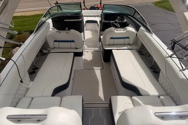 Slide: The Image of 2022 Regal LS6 Surf boat interior with spacious white seating and modern design. - 4