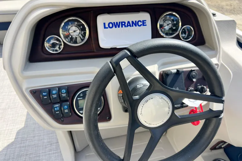 Slide: The Image of 2023 South Bay 224 RS boat dashboard with steering wheel and Lowrance display. - 10