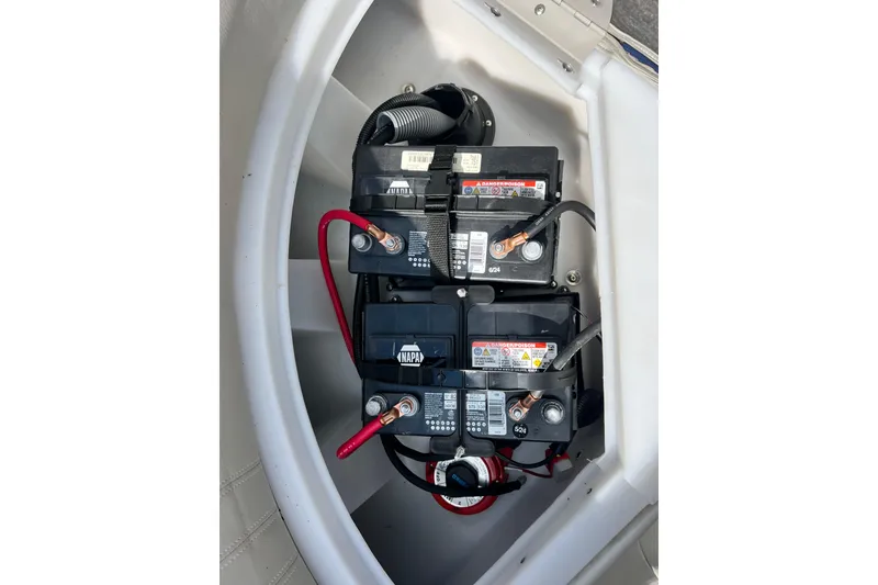 Slide: The Image of 2023 South Bay 224 RS boat battery compartment with dual batteries and wiring. - 11
