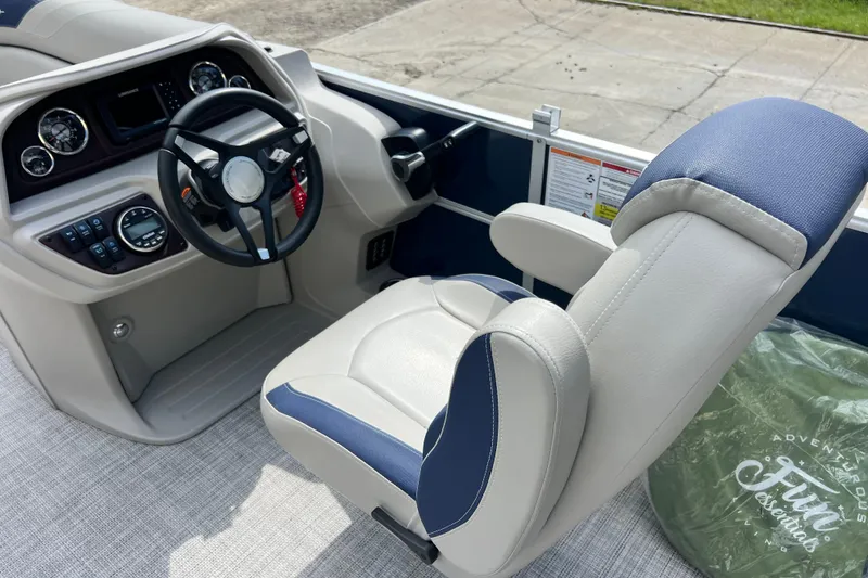 Slide: The Image of Captain's chair and dashboard of 2023 South Bay 224 RS boat, featuring modern controls. - 12