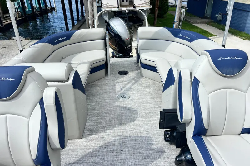Slide: The Image of 2023 South Bay 224 RS pontoon boat interior with plush seating and modern design. - 14